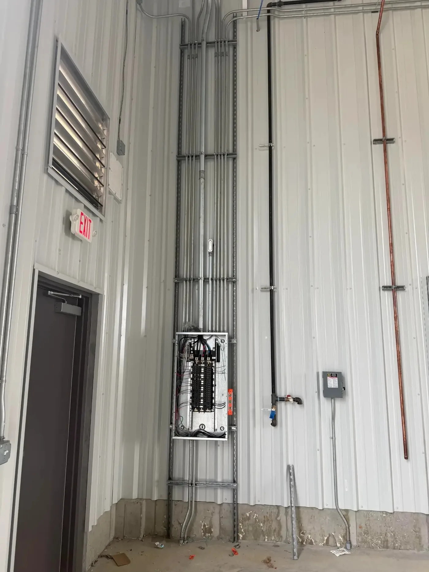 Open commercial panel with organized conduit rack installed by Freedom Electric