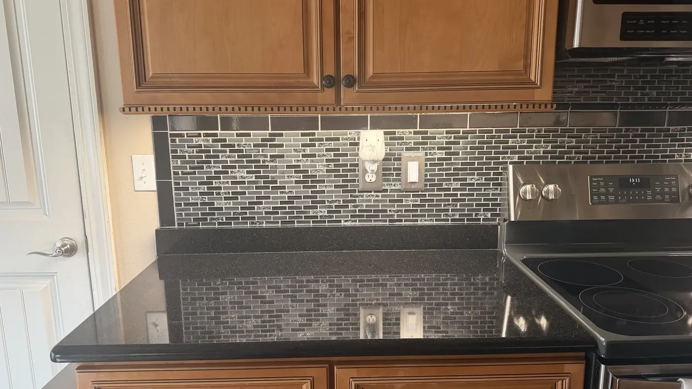Updated kitchen backsplash outlets and efficient lighting by Freedom Electric