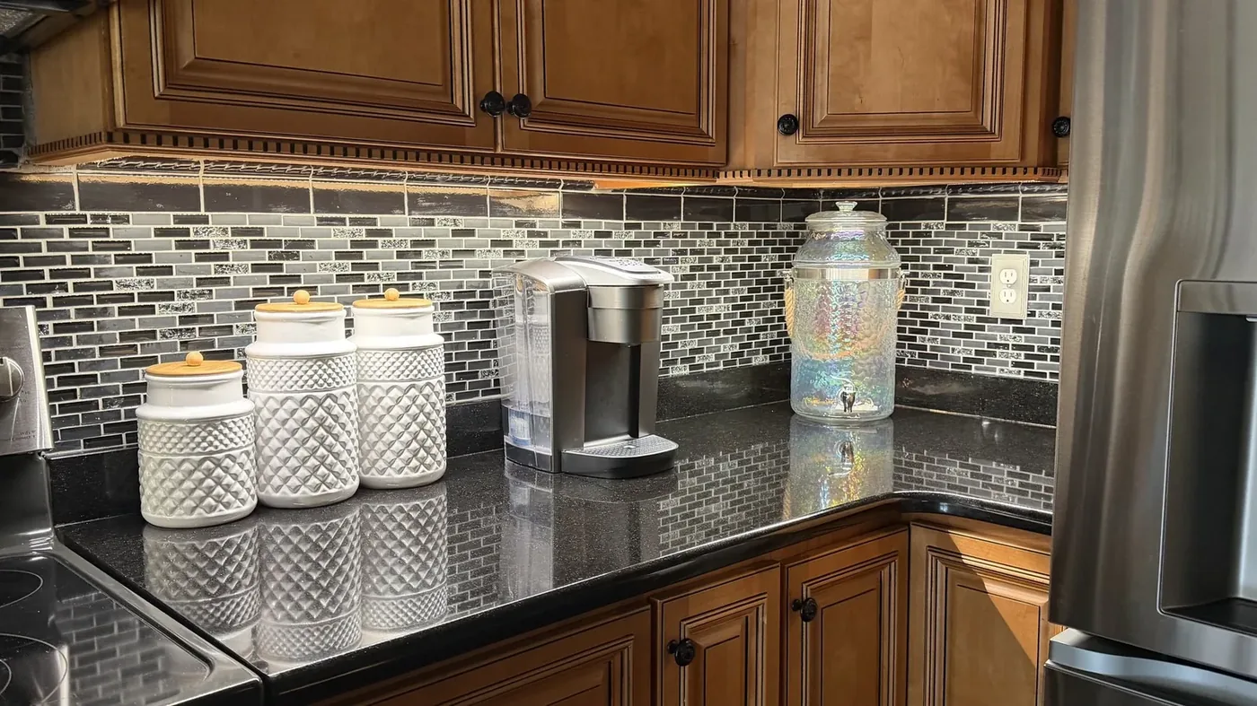 Under-cabinet LED lighting over a kitchen coffee station installed by Freedom Electric