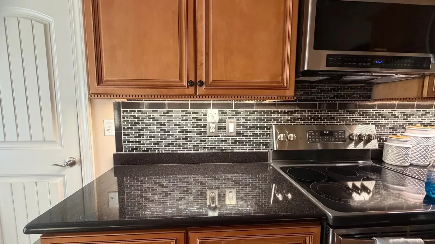Warm under-cabinet LED lighting across a kitchen counter, real job photo